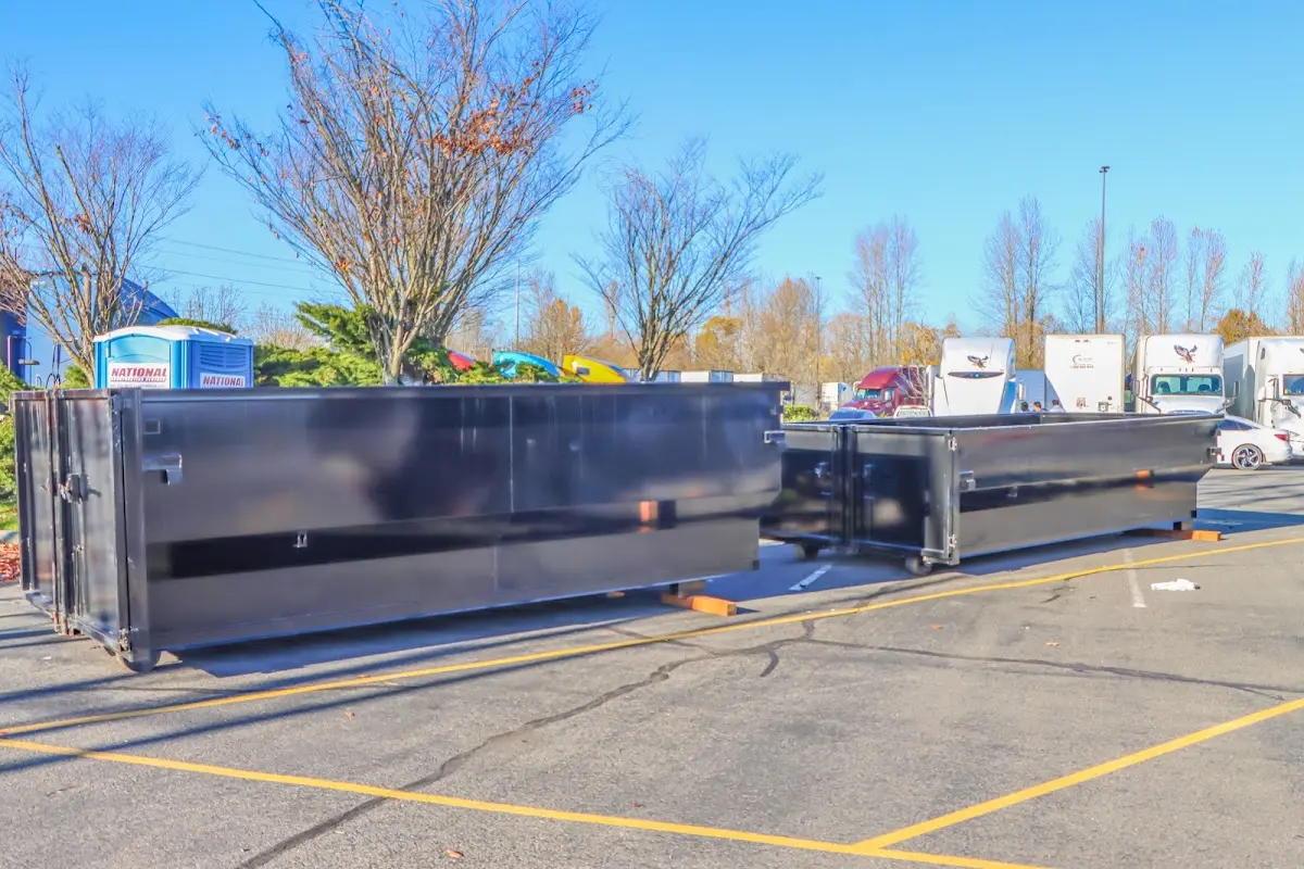 Professional dumpster rental service with roll-off container on residential driveway in Camillus